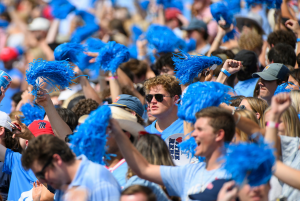 A sea of students wearing light blue cheer on the rebels with blue pom-poms inthe Vaught-Hemingway stadium.
